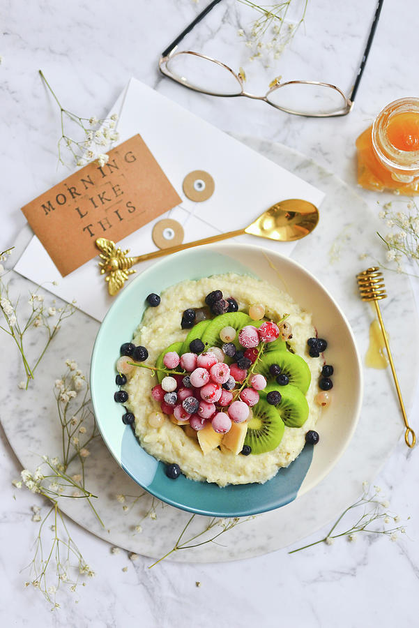 Oatmeal In A Bowl With Frozen Seasonal Fruit Currants Berries Kiwi Photograph by Karolina Smyk