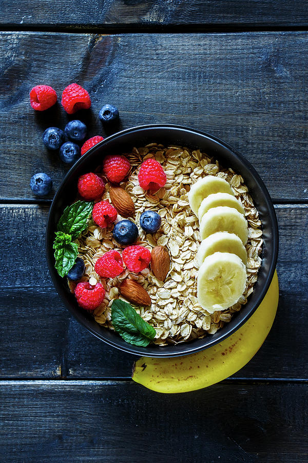 Oatmeal With Berries, Almonds And Bananas In A Bowl top View Photograph by Yuliya Gontar