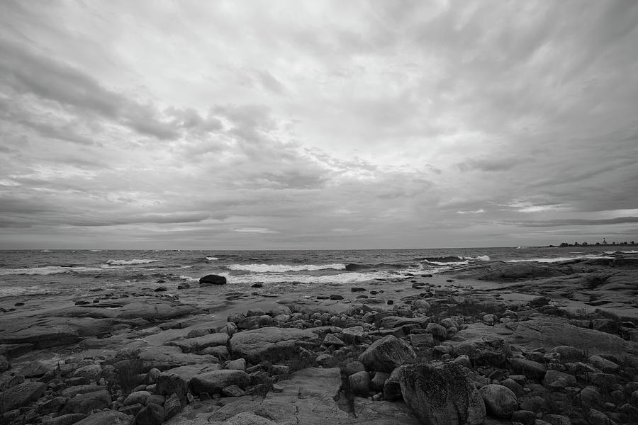 Ocean Waves Rolling Towards A Rocky Beach - Monochrome Photograph