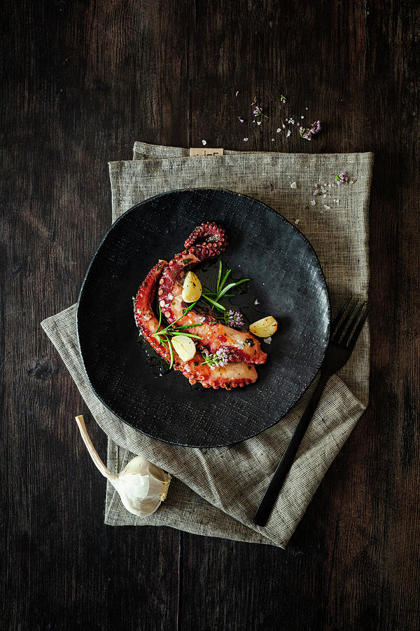 Octopus Fried In Herb Butter With Rosemary And Garlic Photograph by Jan Wischnewski