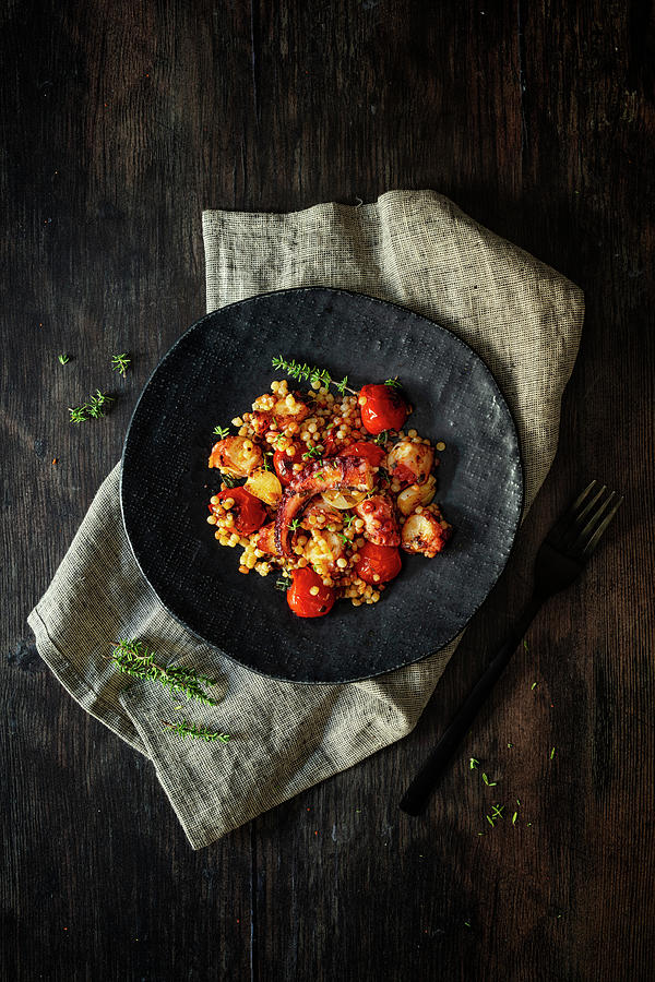 Octopus With Fregola, Tomatoes, Garlic And Thyme Photograph by Jan Wischnewski