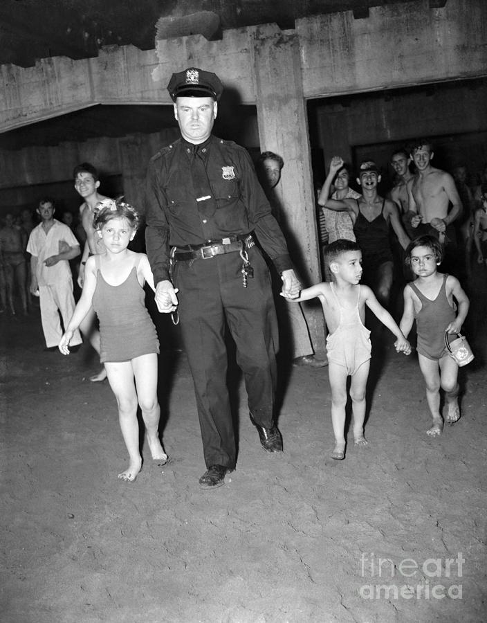 Officer Leads Three Children At Coney Photograph by Bettmann
