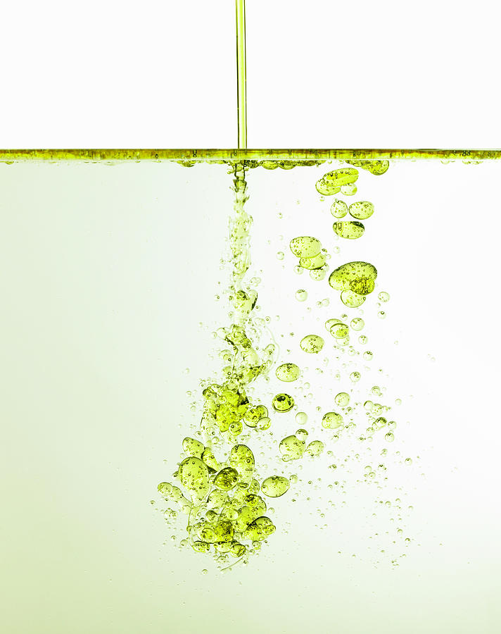 Oil Being Poured Into Water, Studio Shot Photograph by Ryan Mcvay