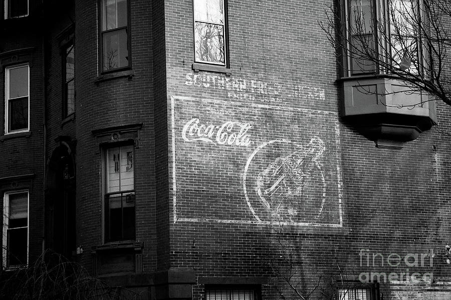 Old advertising poster of soda drink on the brick walls of a building. Photograph by Joaquin Corbalan