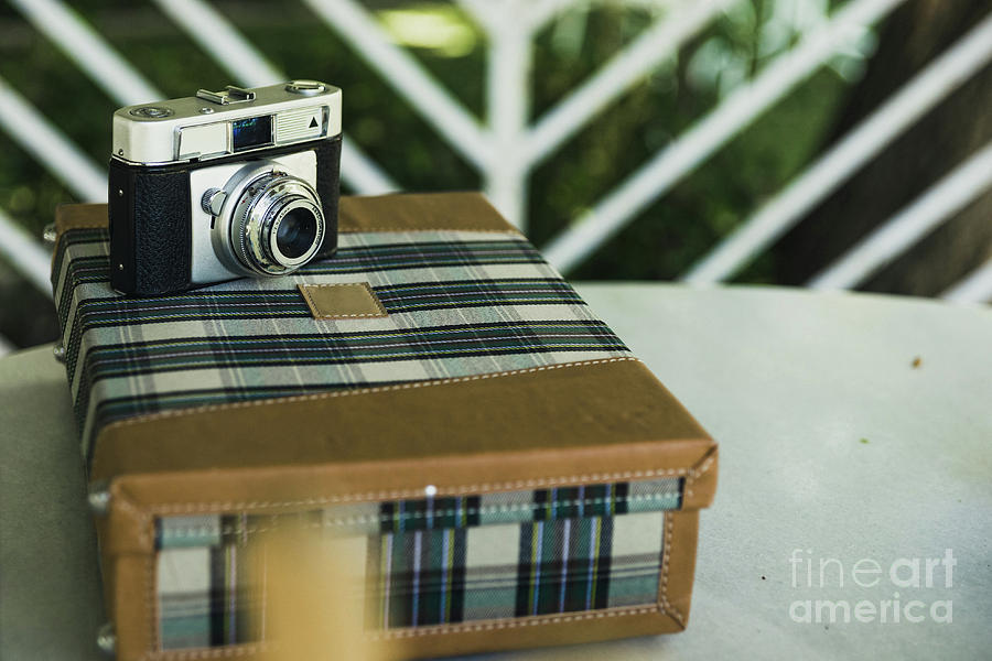  Old analog photo camera on a vintage travel suitcase. Photograph by Joaquin Corbalan
