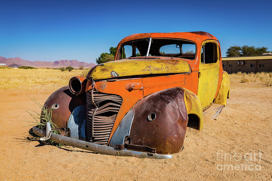 Old and abandoned car in Solitaire, Namibia Photograph by Lyl Dil Creations