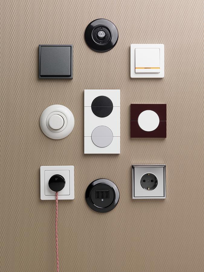 Old And New Light Switches And Plugs Attached To A Wall Photograph by Armin Zogbaum
