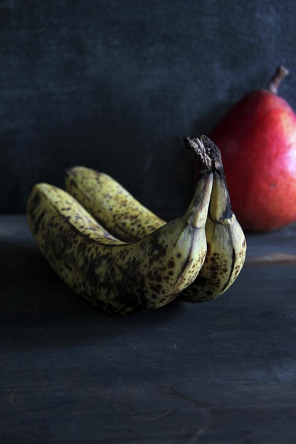 Old Bananas With A Pear Photograph by Patricia Miceli