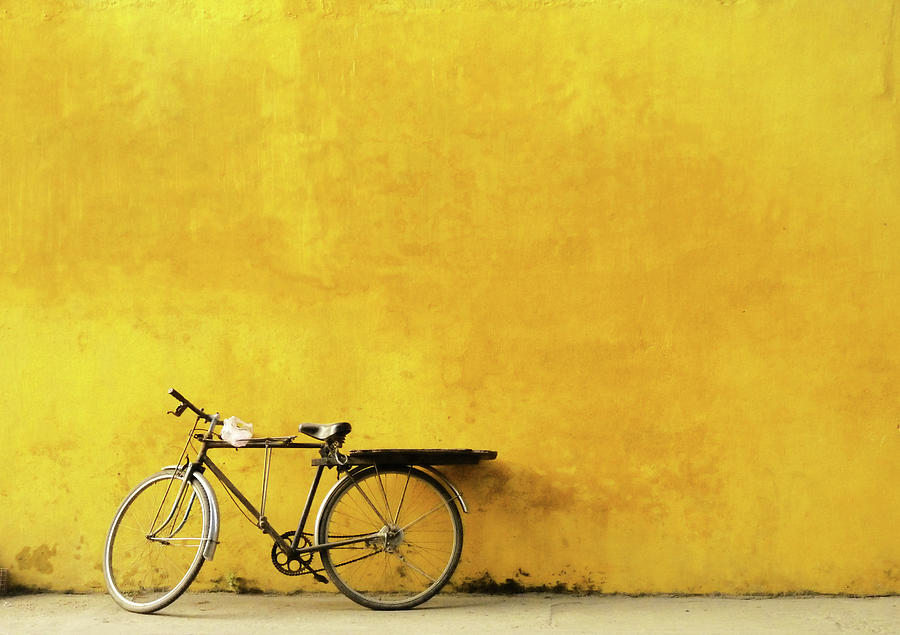 Old Bicycle Parked Against Worn Yellow Photograph by Cati Kaoe