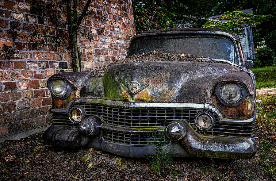 Old Caddy by Brick Wall Photograph by Darryl Brooks