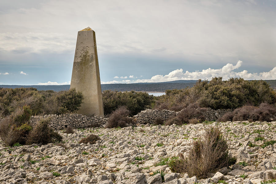 Old concrete triangular pillar on the island of Cres Photograph by