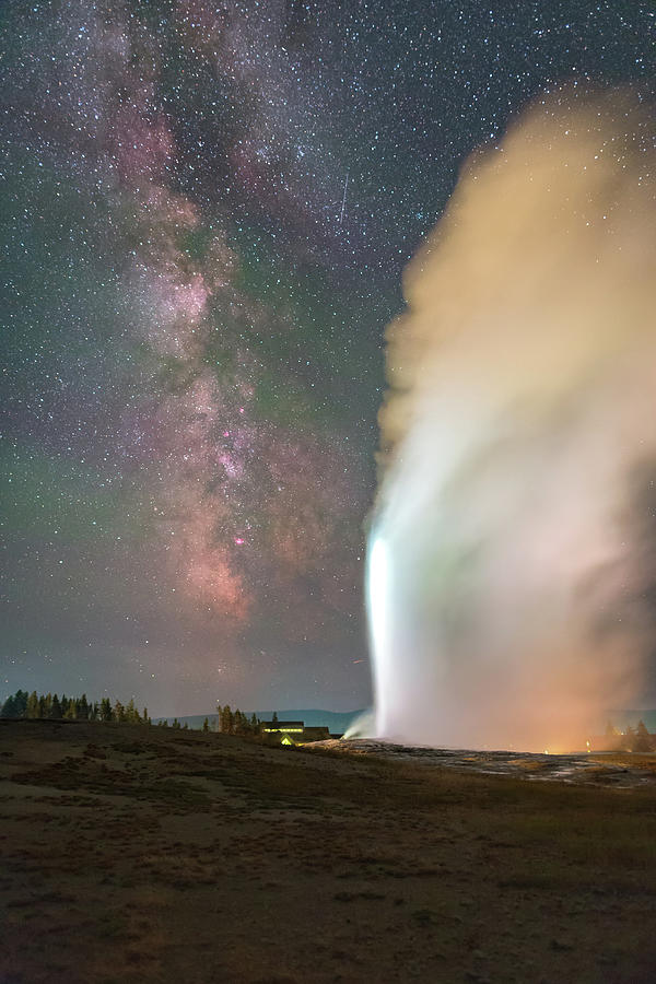 Old Faithful erupts at night Photograph by Alexandru Conu