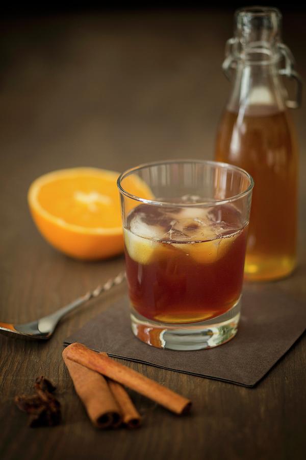 Old Fashioned Rum With Homemade Cinnamon And Orange Syrup Photograph by Jan Wischnewski