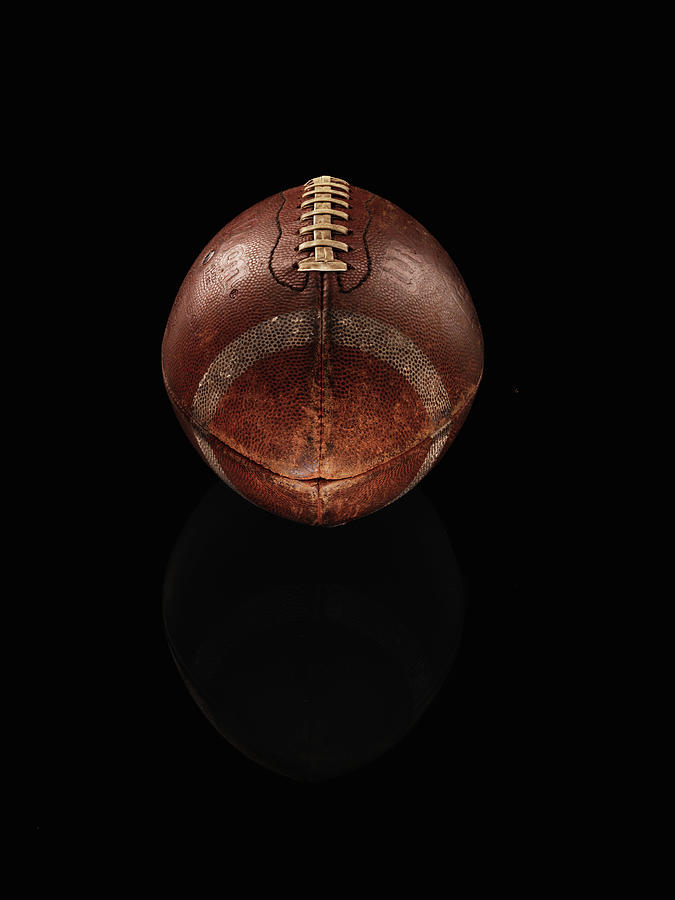 Old Football On Black Background Photograph by Alexander Nicholson