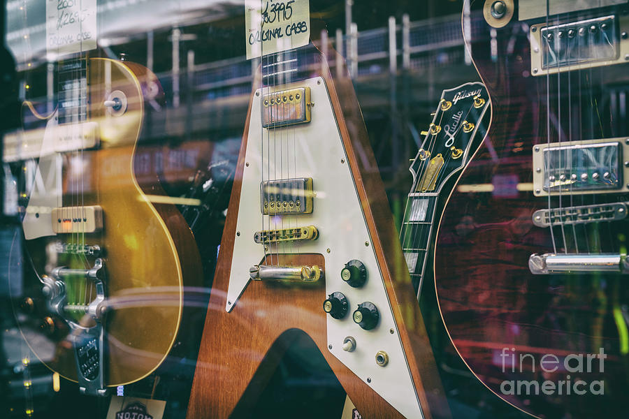 Old Guitars in a Shop Window Photograph by Tim Gainey