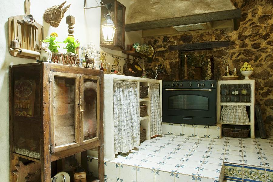 Old Kitchen Furnishings And Modern Cooker On Tiled Platform In Farmhouse Photograph by Blickpunkte