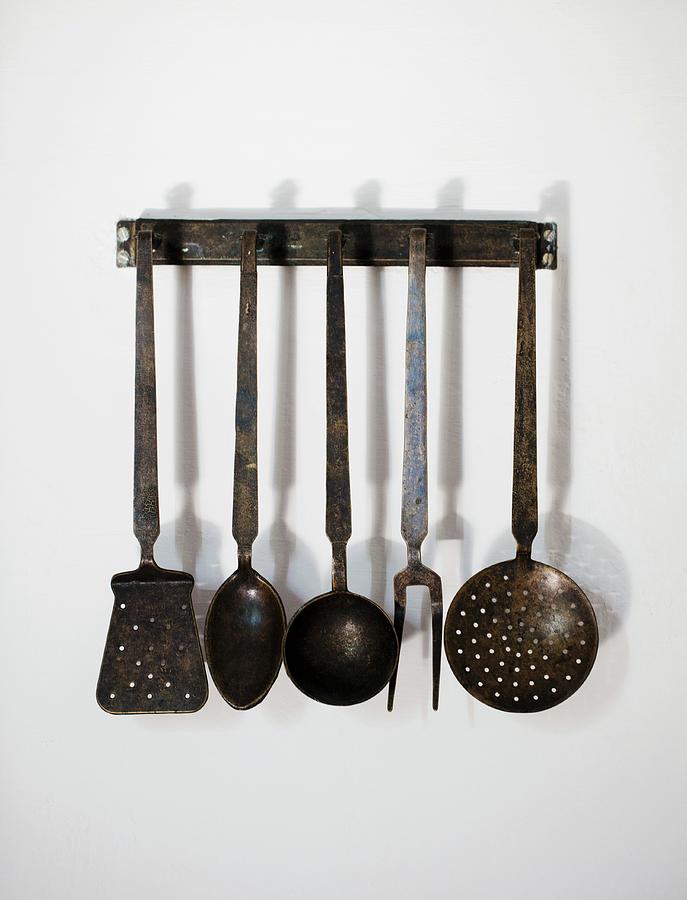 Old Kitchen Utensils Hanging On The Wall Photograph by Cath Lowe