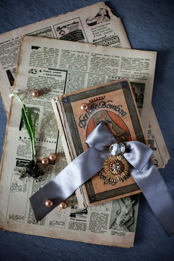 Old Newspaper, Book, Jewellery And Flower Photograph by Alicja Koll