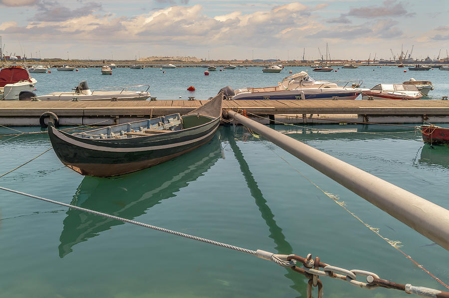 Old portuguese gondola blending with modern life. by Manny DaCunha Old portuguese gondola blending with modern life. by Manny DaCunha
