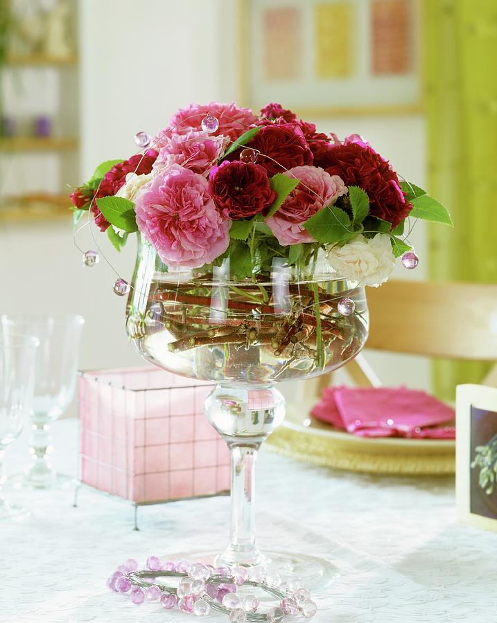 Old Roses In A Stemmed Glass Bowl Photograph by Friedrich Strauss