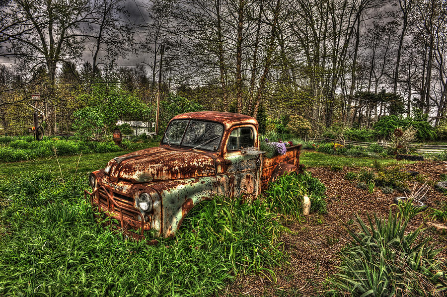 Old rusted car in yard Photograph by Daniel Friend