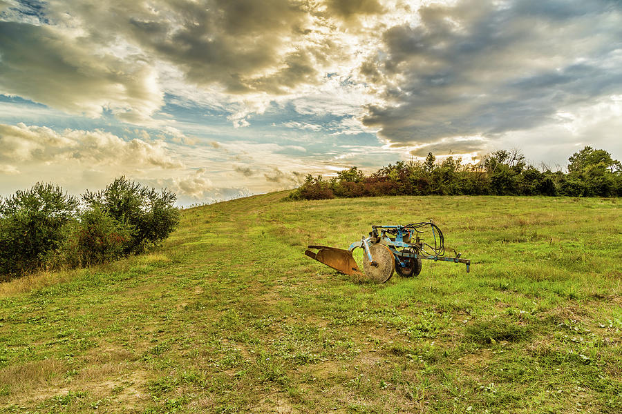 Old Rusty Plow On A Green Hill Photograph by Vivida Photo PC