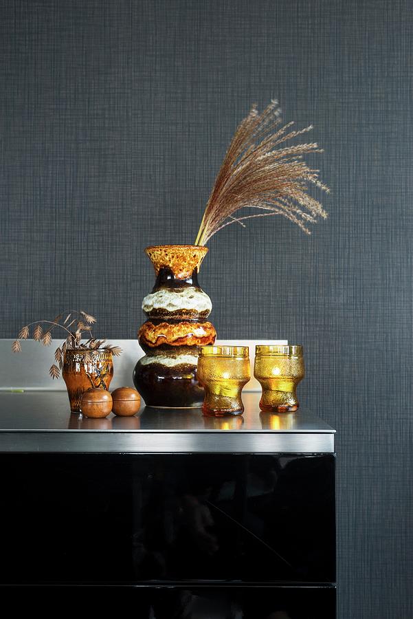 Old Seventies Vases And Glasses Against Grey Wall Photograph by Ulla@patsy