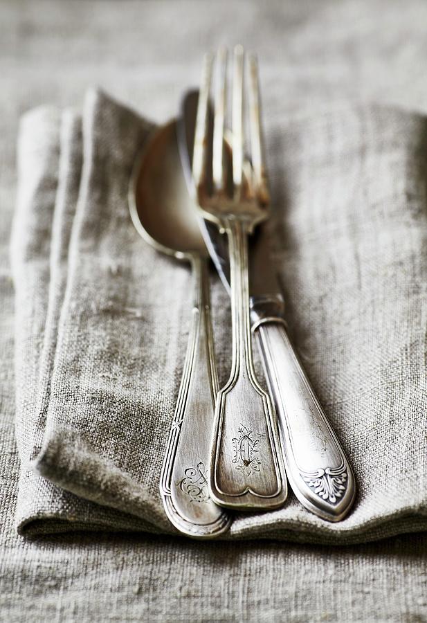 Old Silver Cutlery On A Linen Cloth Photograph by B.&.e.dudzinski