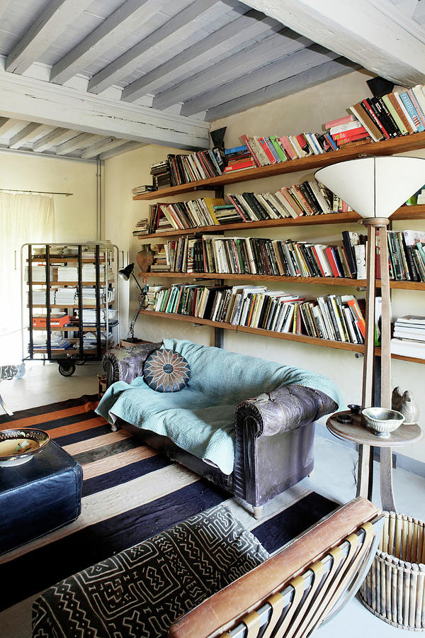 Old Sofa Below Bookshelves In Vintage-style Living Room Photograph by Guy Bouchet