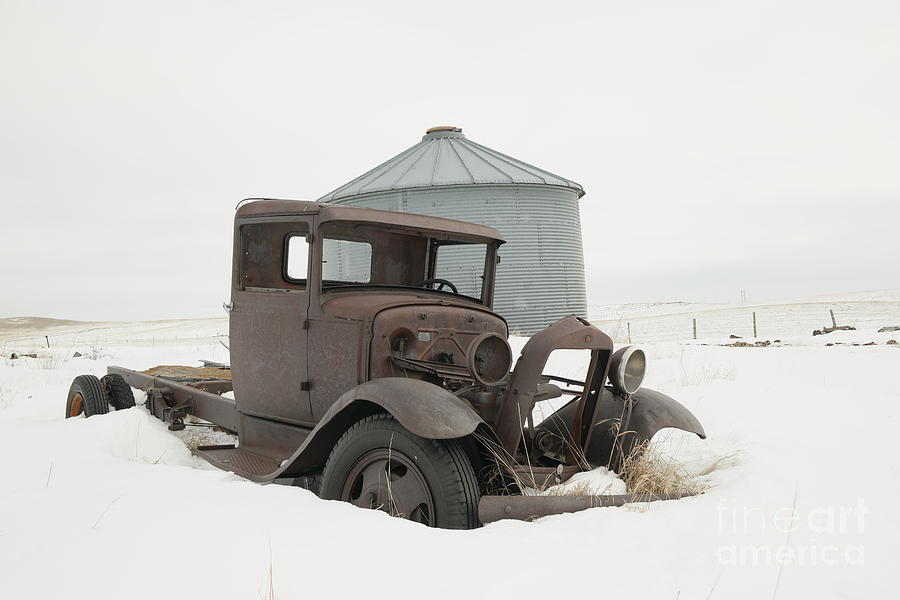 Vintage Photograph - Old truck and grain silo on a gray winter day by Jeff Swan