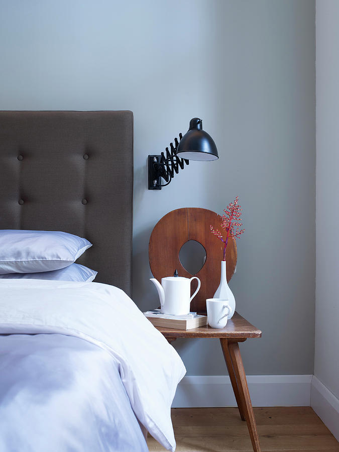 Old Wooden Chair Used As Bedside Table Next To Bed With Button-tufted Headboard Photograph by Matteo Manduzio