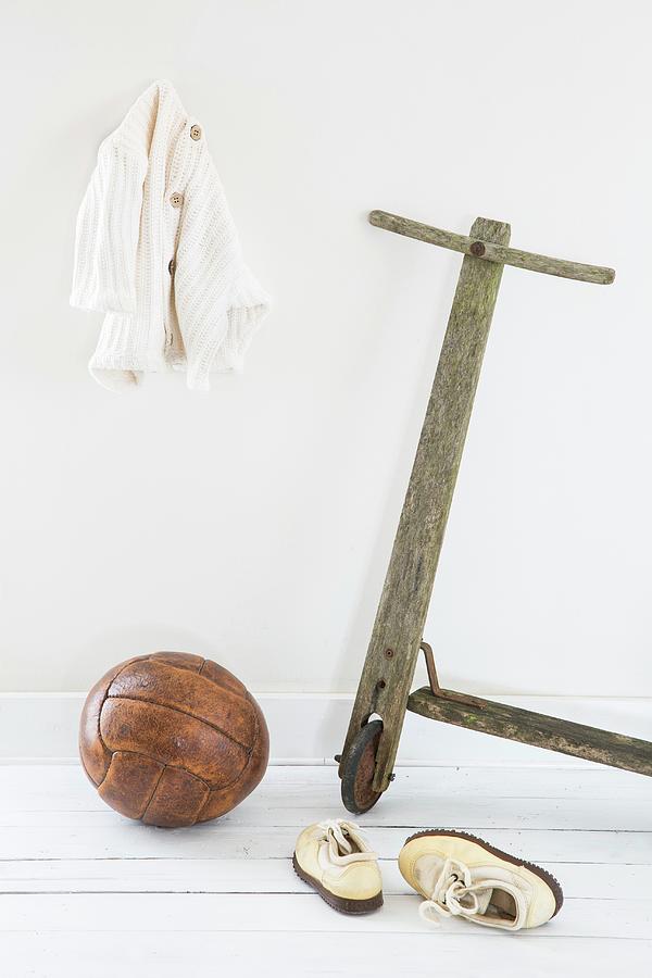 Old Wooden Scooter, Leather Ball And White Childs Shoes Photograph by Catja Vedder