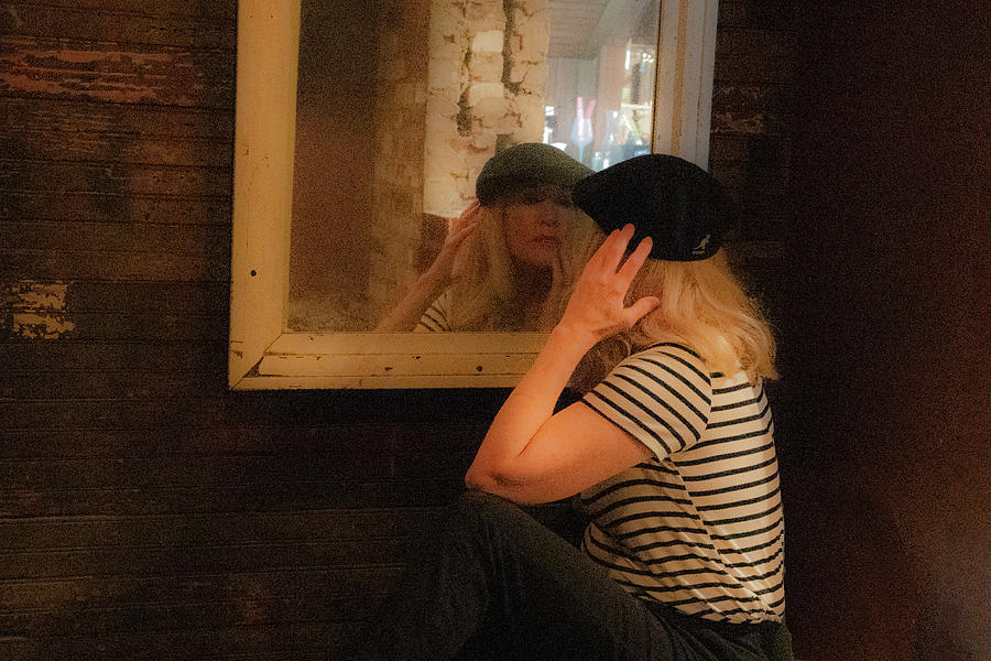 Older attractive lady in beret looking in mirror Photograph by Dan Friend