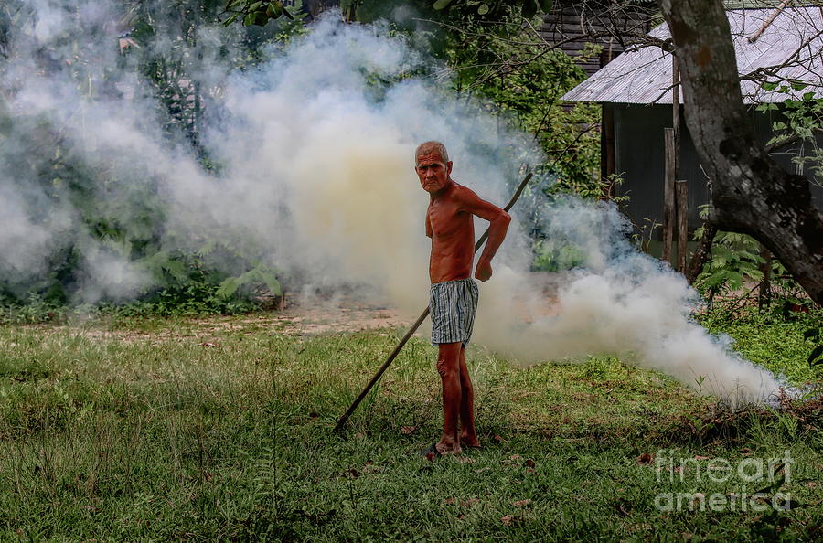 Landscape Photograph - Older Cambodian Male Fields Burning Weeds Look  by Chuck Kuhn