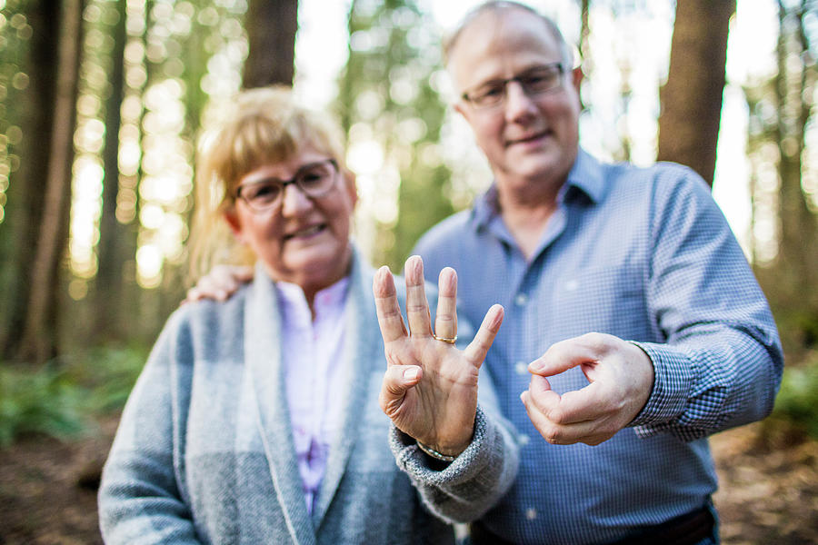Nature Photograph - Older Couple Hold Out 40 With Fingers During 40th Anniversary by Cavan Images