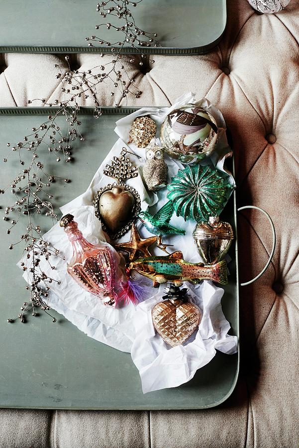 Olive-green Tray Of Vintage-style Christmas Decorations On Upholstered Surface Photograph by Catherine Gratwicke