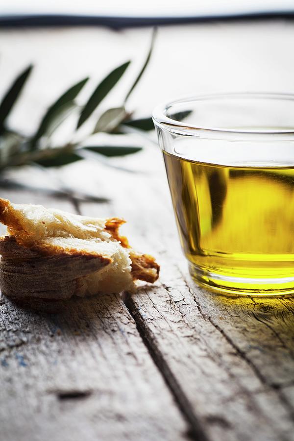 Olive Oil, A Piece Of Bread And An Olive Twig Photograph by Theodosis Georgiadis