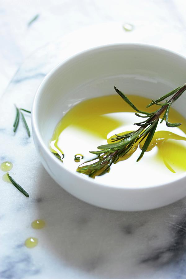 Olive Oil And Rosemary In A White Bowl Photograph by Vivi Dangelo