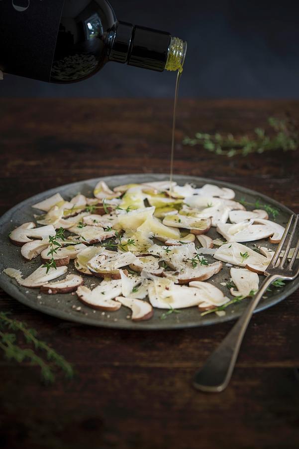 Olive Oil Being Drizzled Over Porcini Carpaccio Photograph by Justina Ramanauskiene