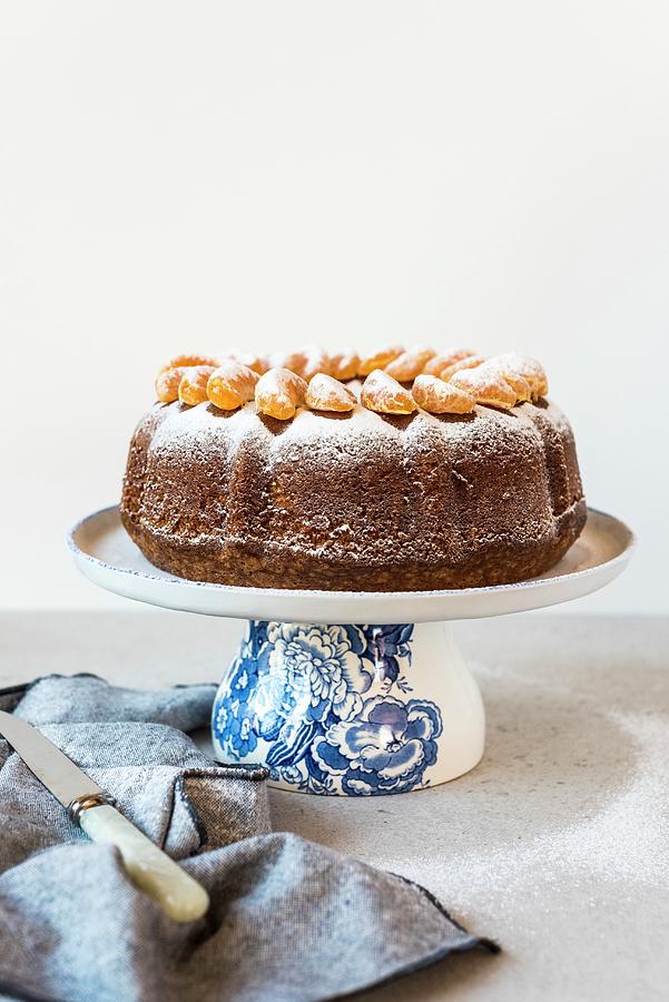 Olive Oil Bundt Cake With Mandarin Segments And Icing Sugar Photograph by Hein Van Tonder