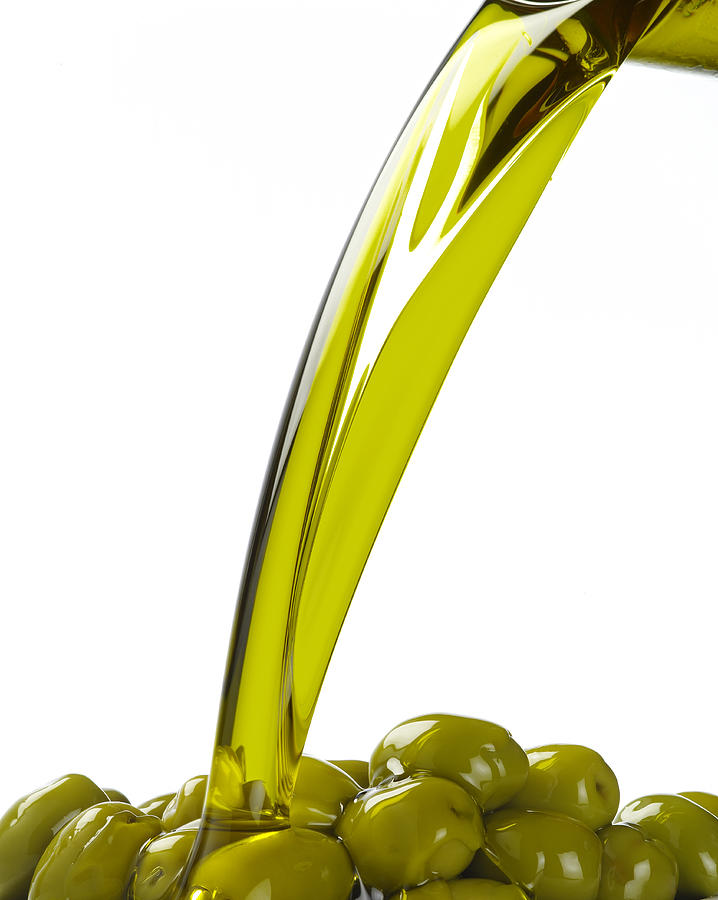 Olive Oil Pouring Over Green Olives Photograph by Domino