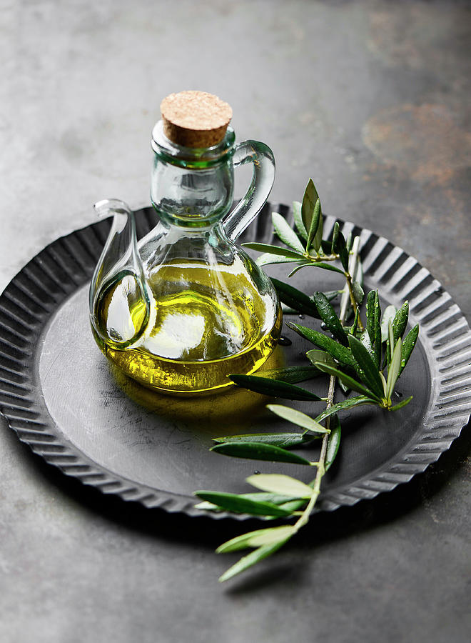 Olive Oil With An Olive Sprig Photograph by Ewgenija Schall