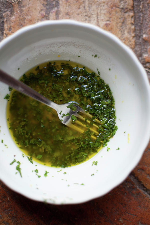 Olive Oil With Herbs In A Bowl Photograph by Eising Studio