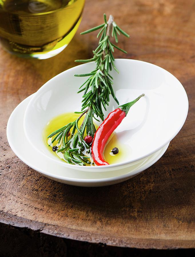 Olive Oil With Rosemary And Chilli Peppers ingredients For A Marinade Photograph by Ewgenija Schall