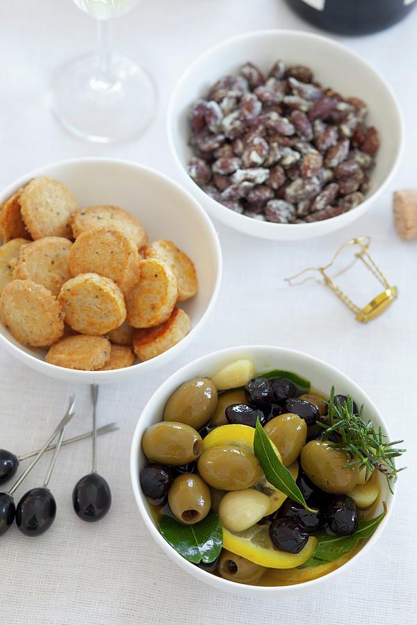 Olives, Cheese Crackers And Salted Almonds Photograph by Studio Lipov