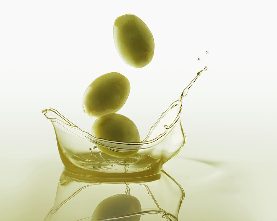 Olives Falling Into Olive Oil Photograph by Krger & Gross