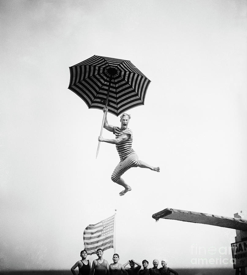 Olympic Swimmer Doing Comic Diving Stunt Photograph by Bettmann