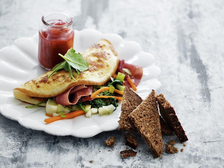 Omelette With Vegetables And Dried Ham Photograph by Mikkel Adsbl