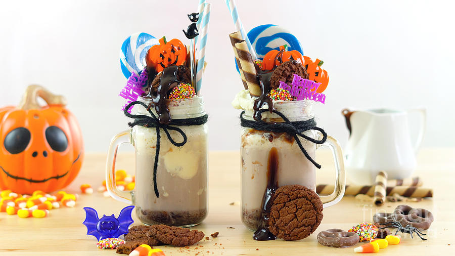 On-trend Halloween freak shakes decorated with candy, cookies and lollipops. Photograph by Milleflore Images