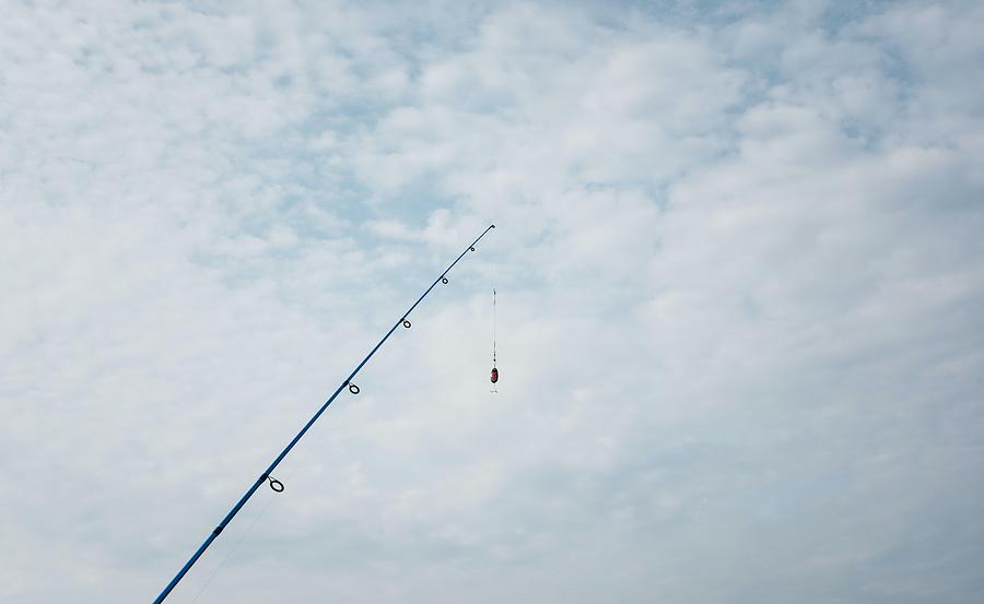 One Fishing Rod Hanging Off A Pier Photograph by Cavan Images - Pixels